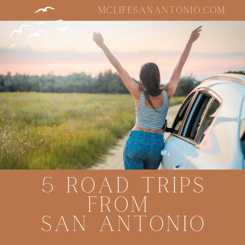 Image shows a woman with arms raised standing next to a car in a field. Text reads "5 Road Trips from San Antonio."