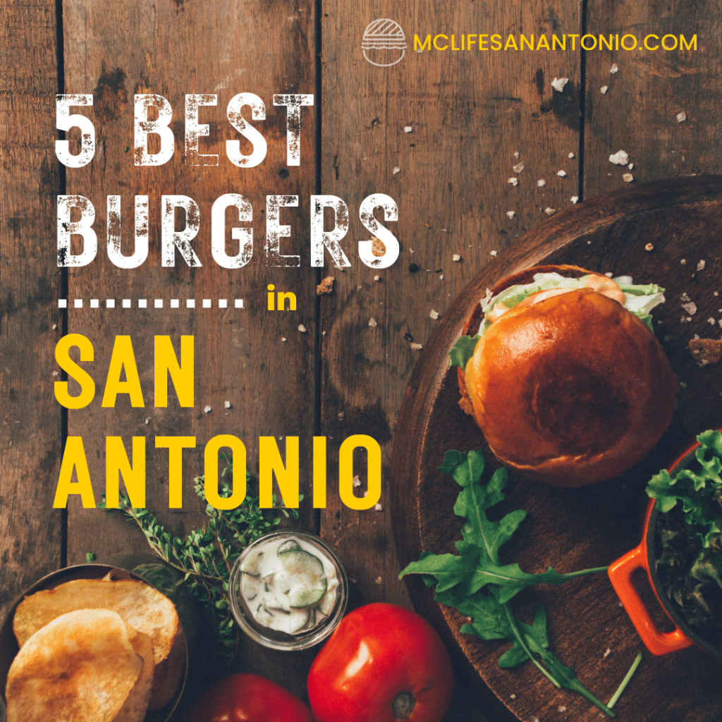 Image shows a burger on a wood table. Text reads "5 Best Burgers in San Antonio." 